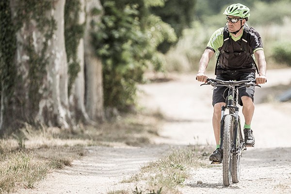 A mountain biker riding an entry level MTB